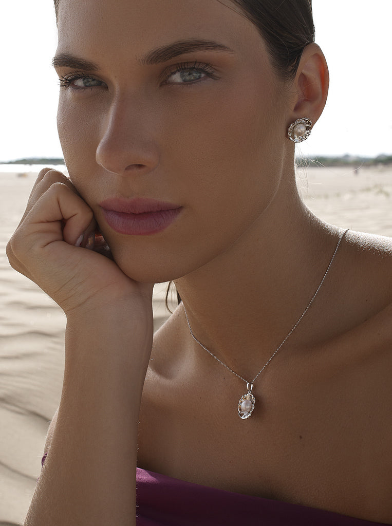 Silver flower earrings with a central pearl