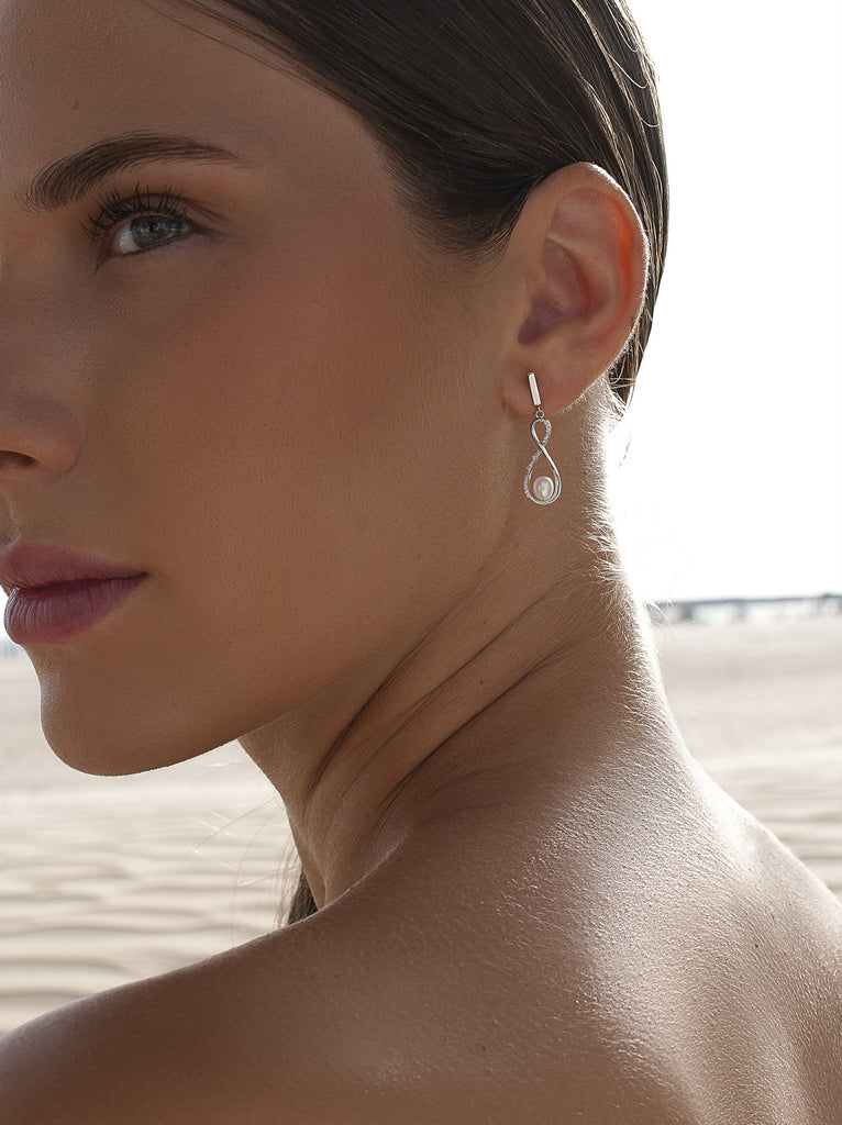 Silver infinity earrings with pearl and cubic zirconia
