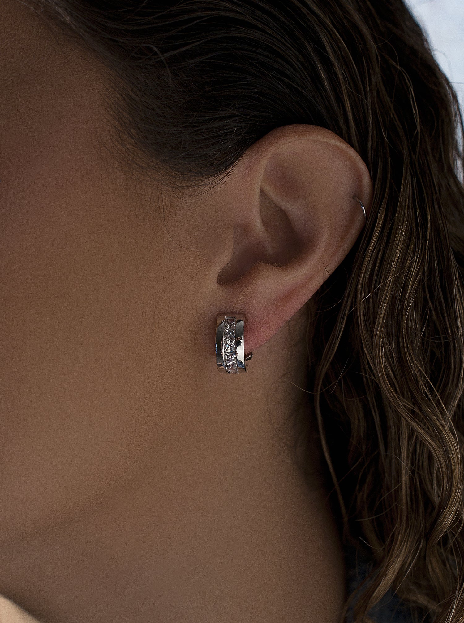 Omega-clasp earrings with faceted princess-cut cubic zirconia.