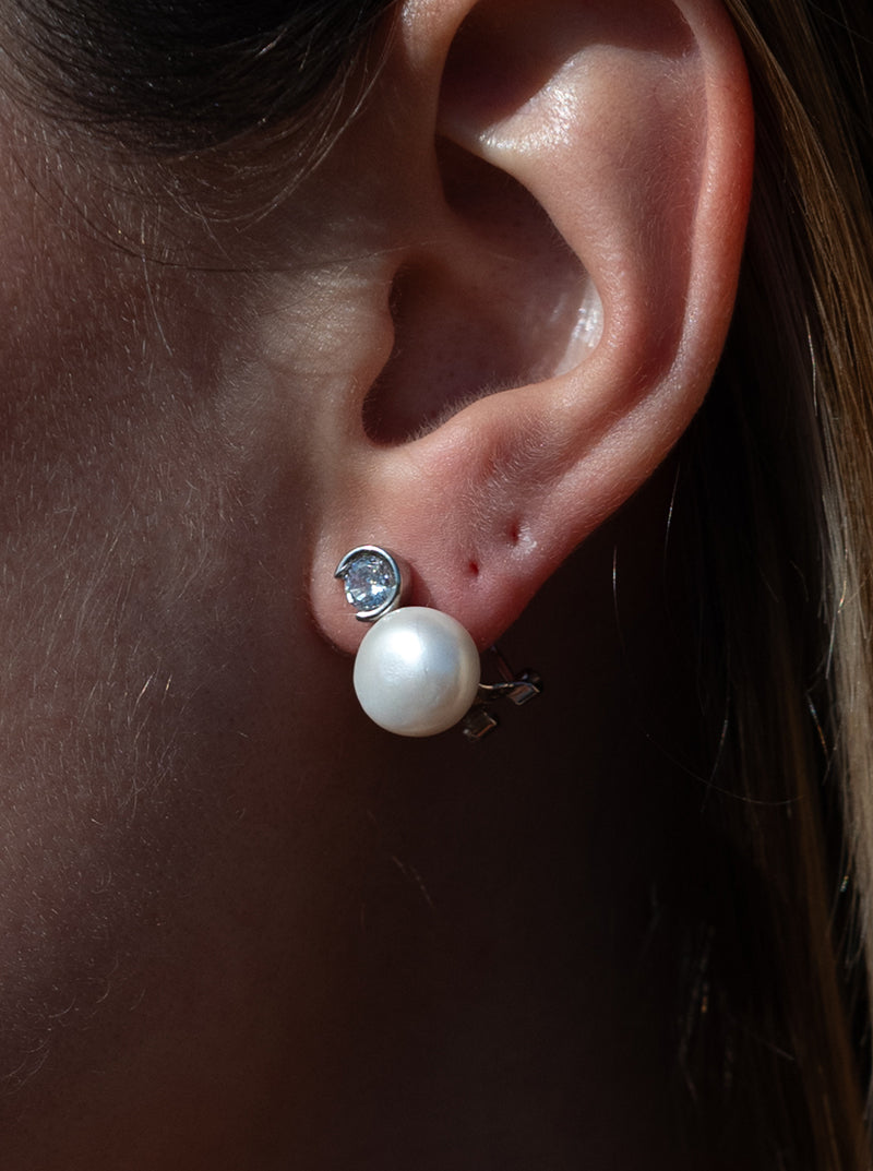 Pearl earrings in a toe-and-toe style with a pearl and round-cut cubic zirconia