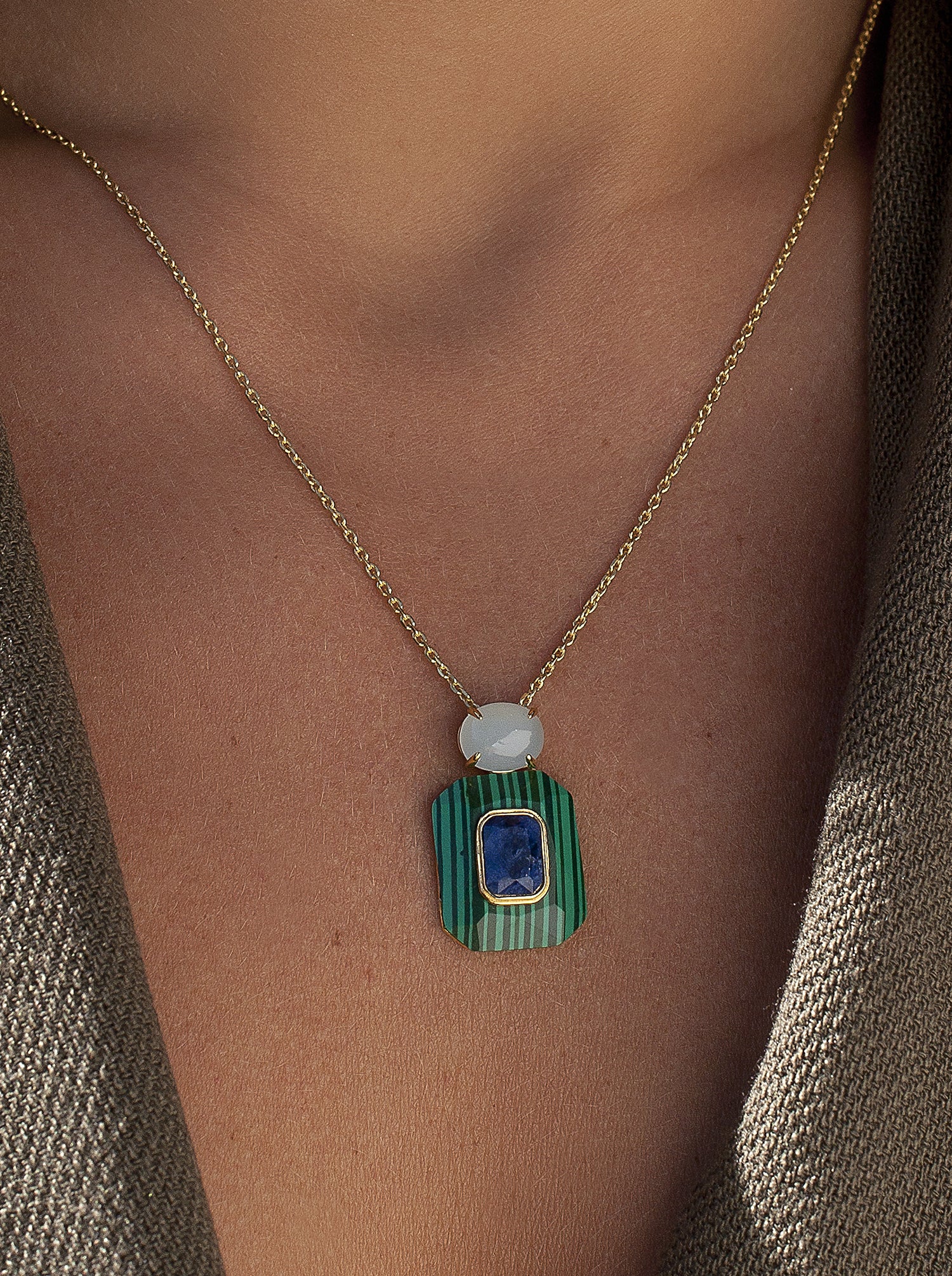 Necklaces with pendants in green tones and central motif with navy blue stones