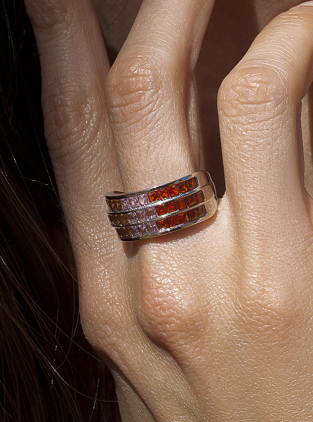Rings with triple-ribbed stones in warm tones